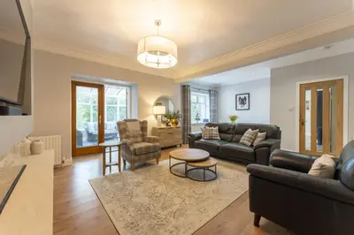 a living room with a couch and a table at The Lindsay House in Stirling
