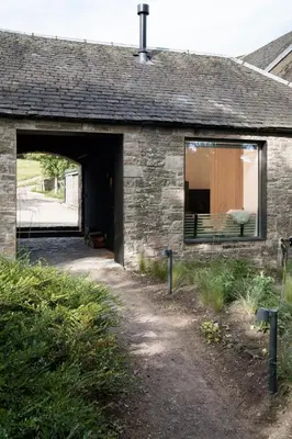 an entrance to a brick building with a doorway at Eastside - Architect designed retreat with wood-fired sauna in Penicuik