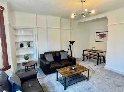 a living room with a couch and a table at Large 2 bed near Glasgow Airport in Paisley