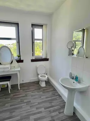 a white bathroom with a toilet and a sink at Large 2 bed near Glasgow Airport in Paisley