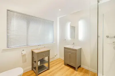 a bathroom with a toilet and a sink and a shower at Peregrine Cottage with Hot Tub in Newton Stewart