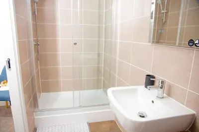 a bathroom with a sink and a shower at Beautiful 5 Bedroom House in Glasgow in Cambuslang