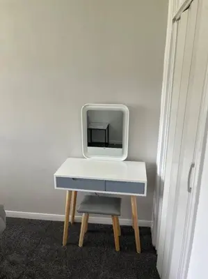 a tv sitting on a table in a room at Erskine Apartment in Erskine