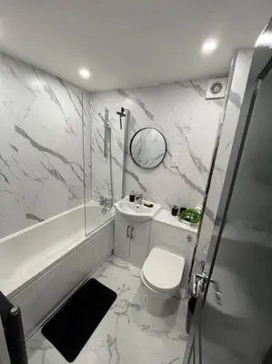 a bathroom with a toilet and a tub and a sink at Erskine Apartment in Erskine