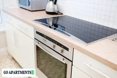 a kitchen with a sink and a stove at Large 2 Bed Edinburgh City Centre Apartment - FREE Parking in Edinburgh