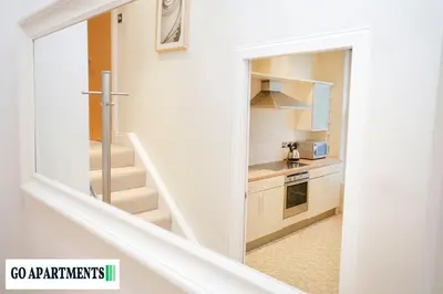 a staircase leading up to a kitchen with a stair case at Large 2 Bed Edinburgh City Centre Apartment - FREE Parking in Edinburgh