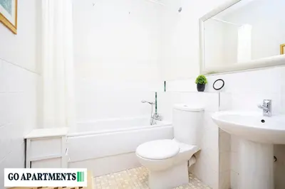 a white bathroom with a toilet and a sink at Large 2 Bed Edinburgh City Centre Apartment - FREE Parking in Edinburgh