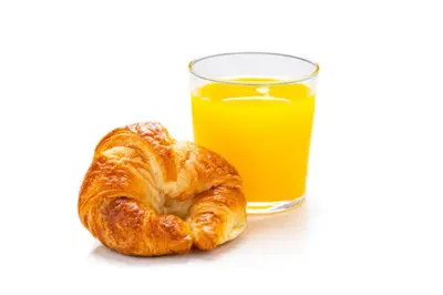 a croissant and a glass of orange juice at Britannia Inn Glasgow in Glasgow