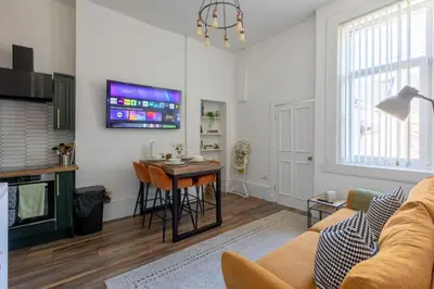 a living room with a couch and a table at Spacious 3 Bedroom Home In Glasgow - Free Parking in Glasgow