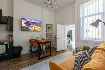 a living room with a couch and a table at Spacious 3 Bedroom Home In Glasgow - Free Parking in Glasgow