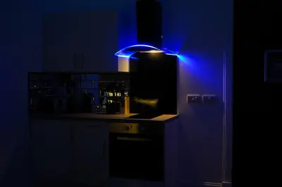 a kitchen with a blue light on a counter at Novana Aparthotel in Glasgow