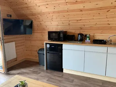 a kitchen with a counter with a microwave and a television at Pond View Pod 2 with Private Hot Tub - Fife - Loch Leven - Lomond Hills in Kelty