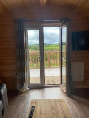 a room with a sliding glass door with a view at Pond View Pod 2 with Private Hot Tub - Fife - Loch Leven - Lomond Hills in Kelty