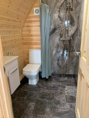 a bathroom with a toilet and a shower at Pond View Pod 2 with Private Hot Tub - Fife - Loch Leven - Lomond Hills in Kelty