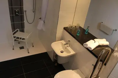 a bathroom with a toilet and a sink and a shower at Horizon Hotel in Ayr