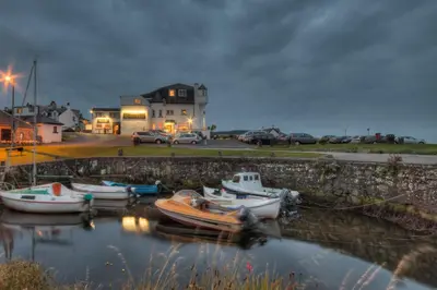 a group of boats are docked in a harbor at Kinloch Hotel, Isle of Arran in Blackwaterfoot