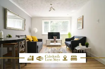a living room with a couch and a table at Rotherwood Apartment in Glasgow