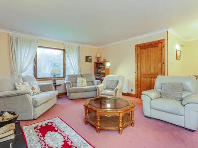 a living room with couches and a coffee table at Bidean Lodge in Glencoe