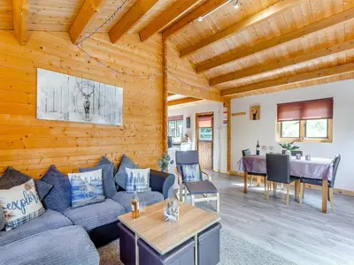 a living room with a couch and a table at The Willows in Glencoe