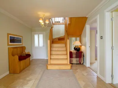 a hallway with a spiral staircase in a home at Carness West in North Ballachulish