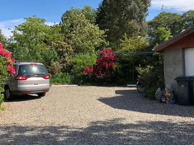 a car parked in a driveway next to a house at Balmillig B&B in Helensburgh