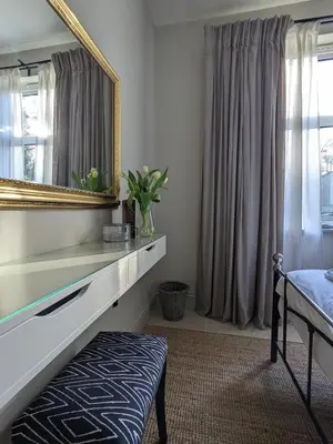a bedroom with a mirror and a bed and a chair at The Posting House in Kilchrenan