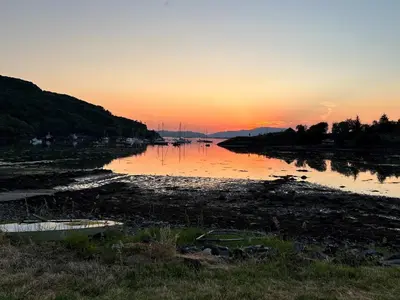 a river with a sunset in the background at Cairnbaan House in Cairnbaan