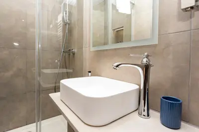 a bathroom with a white sink and a shower at MONO Suites NEW TOWN in Edinburgh