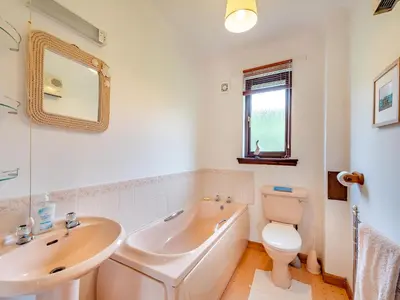 a bathroom with a tub and a sink and a toilet at Glenview in Appin