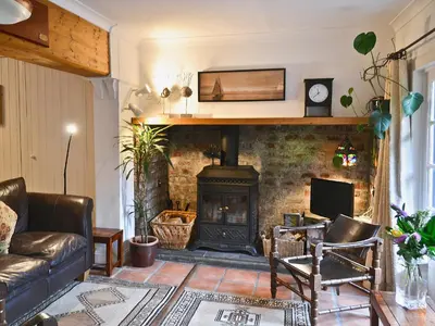 a living room with a fireplace and a couch at Gareside Lodge in Rhu