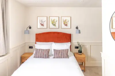 a bedroom with a white bed with two pillows at Grove House Hotel in Edinburgh