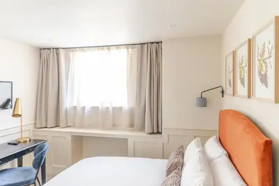 a bedroom with a bed and a window at Grove House Hotel in Edinburgh