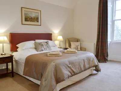 a bedroom with a bed with two towels on it at The Factors House - 25752 in Kilmartin