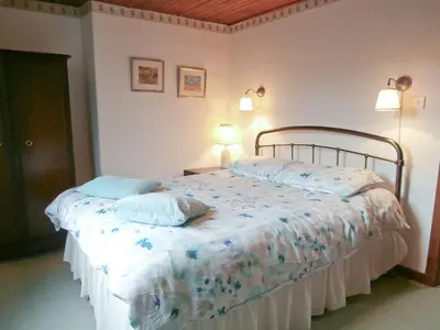 a bedroom with a bed with two pillows on it at 15 Cairnbaan Cottage in Cairnbaan