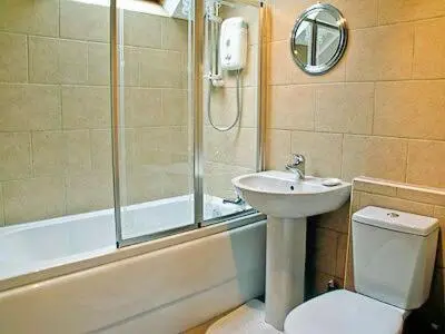 a bathroom with a sink and a toilet and a shower at 15 Cairnbaan Cottage in Cairnbaan