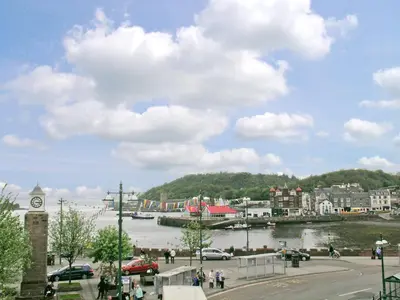 a view of a town with a river and a clock tower at Kerrera View in Oban