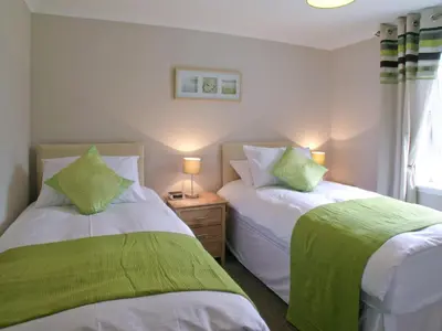 two beds sitting next to each other in a bedroom at Kerrera View in Oban