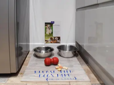 a kitchen with two bowls and a sign that says there was a dog food line at Tigh Raineach in Strathyre