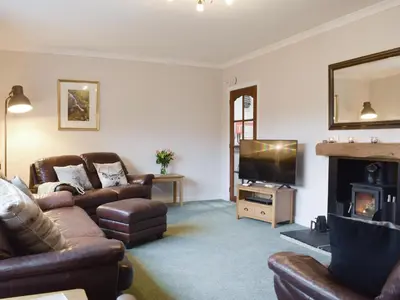 a living room with two couches and a television at Tigh Raineach in Strathyre