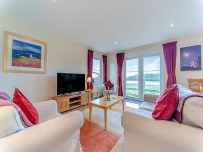 a living room with two white couches and a television at Osprey Cottage- 27939 in Stirling
