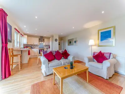 a living room with two white couches and a table at Osprey Cottage- 27939 in Stirling