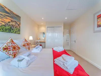 a bedroom with two beds with towels on them at Osprey Cottage- 27939 in Stirling