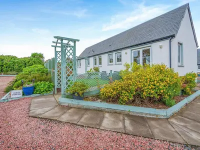 a house with a garden in front of it at Barn Owl Cottage - 27941 in Stirling