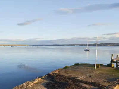 a view of a body of water with a sail boat at Old Inzievar in Blairhall