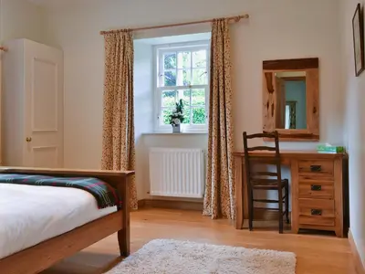 a bedroom with a bed and a desk and a window at Westerton Lodge - Srrh in Crieff
