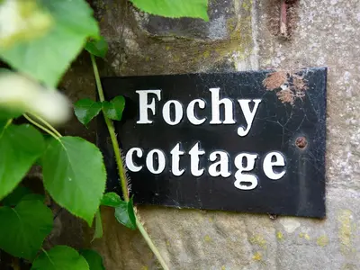 a sign on a wall that reads fooky cottage at Fochy Cottage in Milnathort