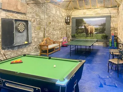 a room with a pool table and a wall with a picture of a cow at The Hayloft in Milnathort