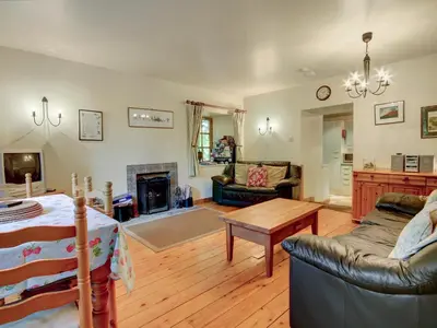a living room with a couch and a table at Coach House in Ratho