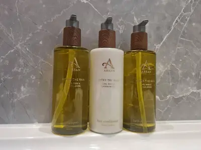 a trio of three bottles sitting on a shelf at Kings Reach - Dunadd Cottage in Lochgilphead