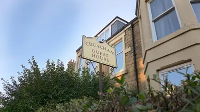 a sign for a guest house in front of a building at Cruachan Guest House in Edinburgh